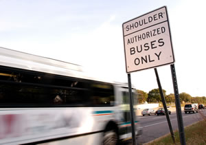 Bus driving on hwy shoulder