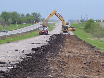 Machine digs up highway