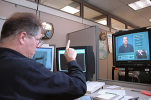 Man signing to a TV monitor