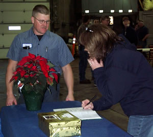 Man, woman signing guest book