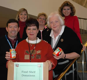 Group of people holding food shelf box