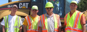 4 men in construction vests, hats