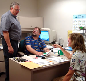 3 people around desk