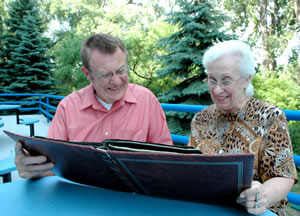 Man, woman looking at photo album