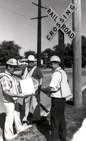 3 men at railroad crossing