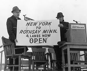 2 men holding banner