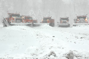 Gang of five snowplows pushing snow