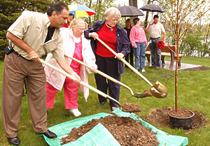 Vicky Stary, the widow of Ed Stary, joined Khani Sahebjam, Metro District engineer, and Lt. Gov./Commissioner Carol Molnau to plant a tree