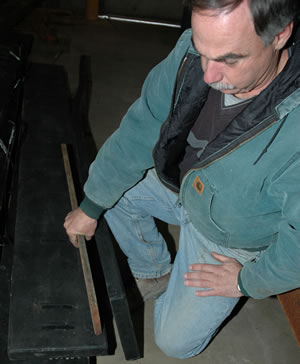 Man showing 2 plow blades side by side