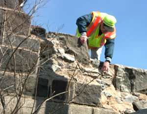 Man inspecting damaged bridge