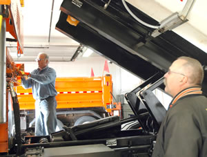 2 men working on truck