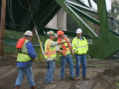 4 men in safety vests