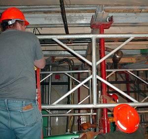 2 men working in boiler room