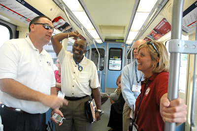 4 people standing inside LRT