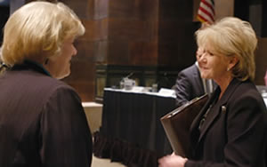 2 women chatting at public hearing