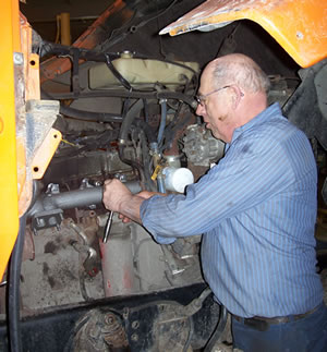 Man fixing snowplow