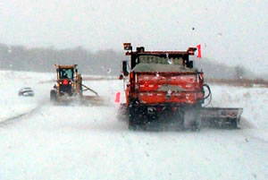 Snow plows plowing heavy snow