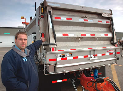 Man next to tow plow truck