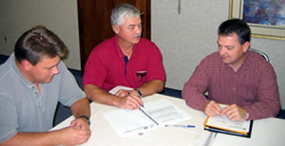 3 men at a table