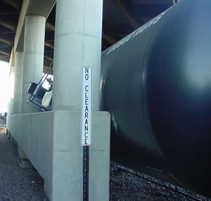 Derailed train car wedge against bridge pier