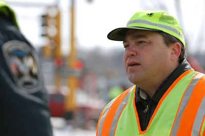 Man in safety vest, hat