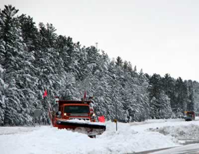 Truck plows snow