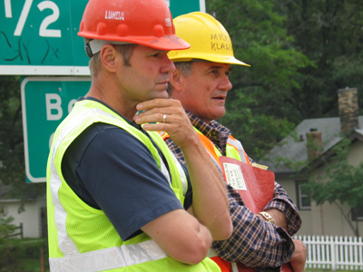 Micky Klasen, Mn/DOT Bridge Supervisor, and Bruce Reihl, Project Superintendent Lunda Construction Project Supervisor, supervising the sidewalk and road removal. Photo by Jenny Seelen