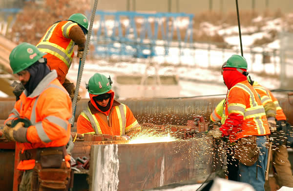 4 workers building a bridge