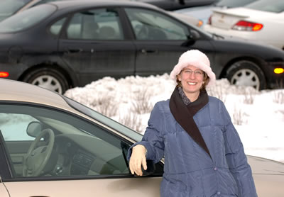 Woman leaning against car