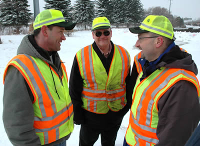 3 men in safety vests