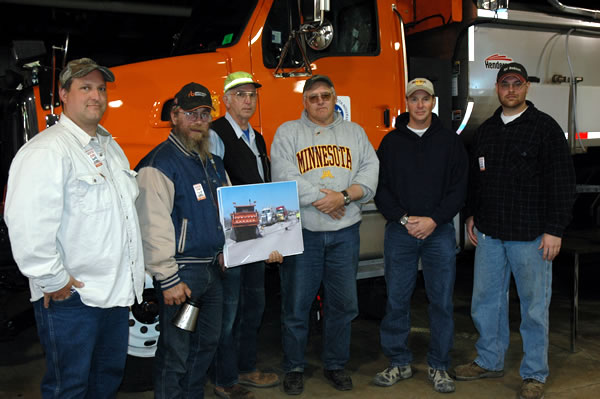 6 men next to dump truck