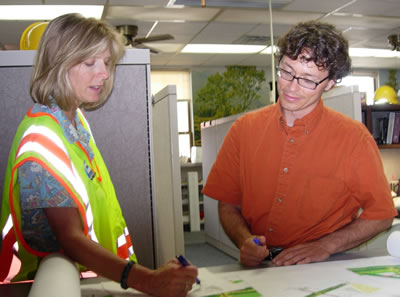 Woman, man looking at plans