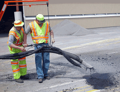 2 workers filling pothole