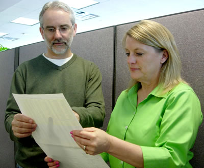 Man, woman reviewing project list