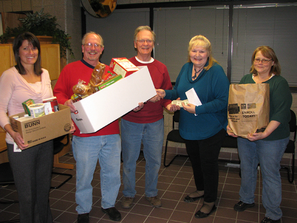 5 people holding bags of food