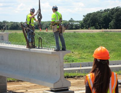 Angel Staples observes the Hwy 14 bridge construction project in North Mankato. 