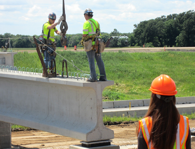 Angel Staples observes the Hwy 14 bridge construction project in North Mankato.