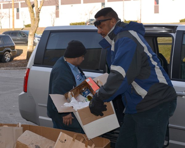 Photo of Jarvis Keys delivering food and cash to Second Harvest Food Bank