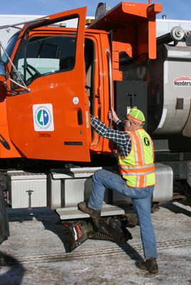 Man demonstrating proper three-point entry into a MnDOT truck