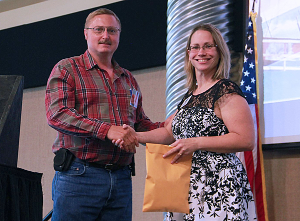 Mark Barnes presented gift cards to Tami Klucas