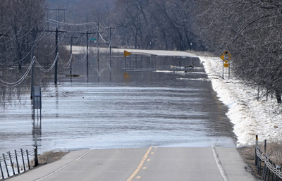 Flooded river goes over road