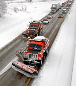 Photo of snow plows clearing a Minnesota roadway.