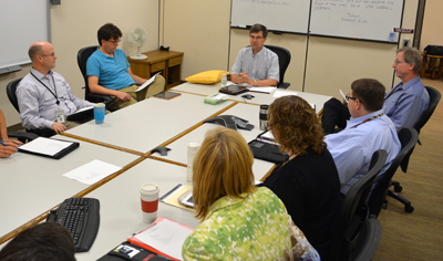 Photo of Mark Gieseke leading a staff meeting of the Transportation System Management Office.
