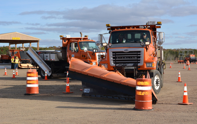 Photo of snowplow moving through rodeo course.