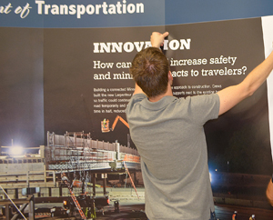 Photo of Adam Peterson setting up State Fair display.