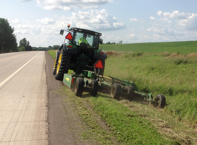 Photo Roger Wersal mowing roadside.