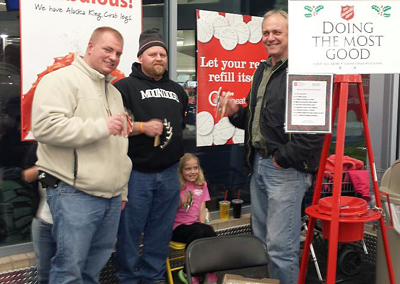 Photo of Chris Hanson, Mike Meffert and Steve Schoeb ringing bells at a Salvation Army Red Kettle stand