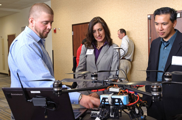 Photo of Brian Steuve, Nancy Daubenberger and Darwin Yasis at the Minnesota Transportation Conference in Bloomington.