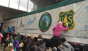 Photo of people signing the truck hauling the national Christmas tree.