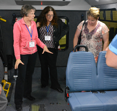 Photo of Kathy Fuller explaining bus specifications.